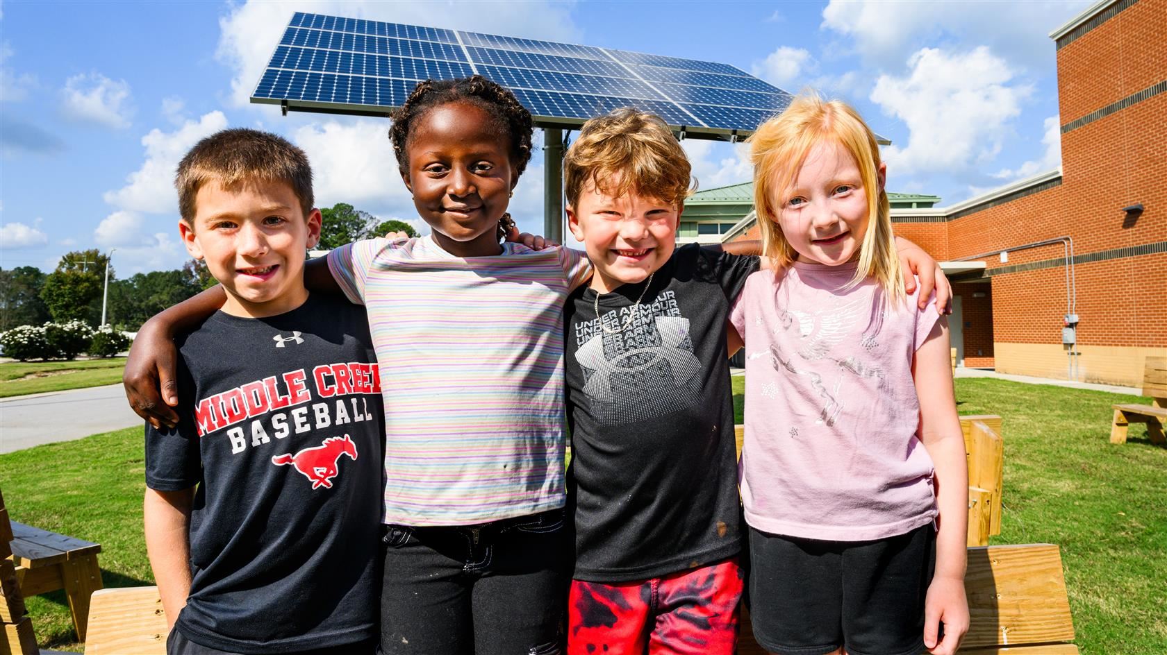 lincoln heights students in front of solar panel